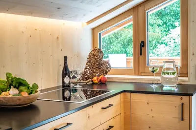 a kitchen with a counter with a bowl of fruits and vegetables at Unterhuberhof in Albes