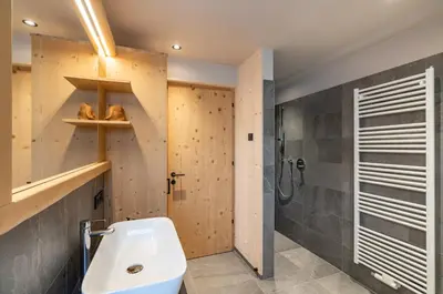 a bathroom with a sink and a shower at Unterhuberhof in Albes