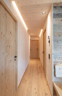 a hallway with a wooden floor and a door at Unterhuberhof in Albes