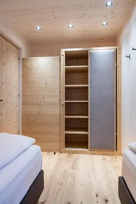 a bedroom with two beds and a closet at Unterhuberhof in Albes