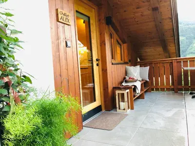 a porch of a wooden cabin with a door at Unterhuberhof in Albes