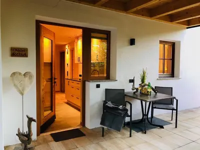 a dining room with a table and a room with a heart sign at Unterhuberhof in Albes