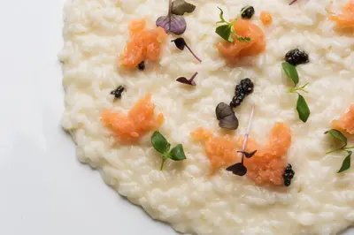a plate of risotto with carrots and other vegetables at Ciampedie Luxury Alpine Spa Hotel in Vigo di Fassa
