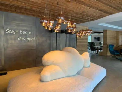 a white sculpture of a bear sitting on a table at Ciampedie Luxury Alpine Spa Hotel in Vigo di Fassa