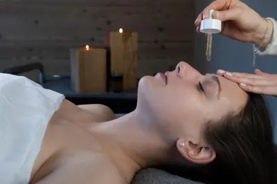 a woman laying on a bed getting her face washed at Ciampedie Luxury Alpine Spa Hotel in Vigo di Fassa