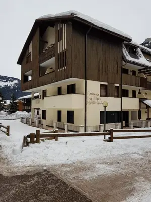 a large building with snow in front of it at Des Alpes 1 in Canazei