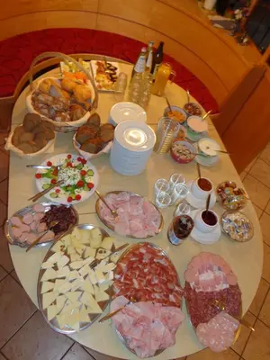 a table topped with lots of different types of food at Gasthof St. Ulrich in Meltina