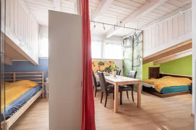 a room with a dining table and two beds at White Tower of Love in Bressanone