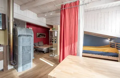 a room with two bunk beds and a red curtain at White Tower of Love in Bressanone