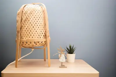 a wicker chair on a wooden table with a plant at White Tower of Love in Bressanone