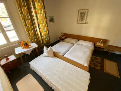 a hotel room with two beds and a window at Gasthof Albergo Ressmair in Merano