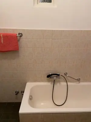 a bath tub in a bathroom with a red towel at Gasthof Albergo Ressmair in Merano