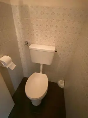 a bathroom with a white toilet in a room at Gasthof Albergo Ressmair in Merano