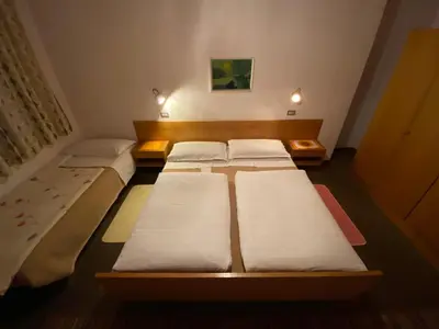 a row of beds in a small room at Gasthof Albergo Ressmair in Merano