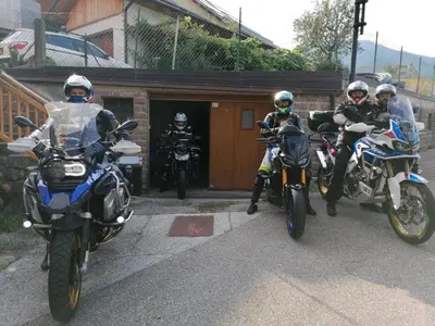 three people on motorcycles parked in front of a building at B&B SEGONZANO in Segonzano