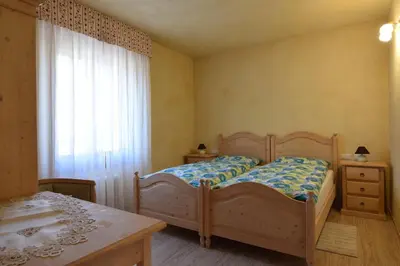 a bedroom with a bed and a table and a window at B&B SEGONZANO in Segonzano