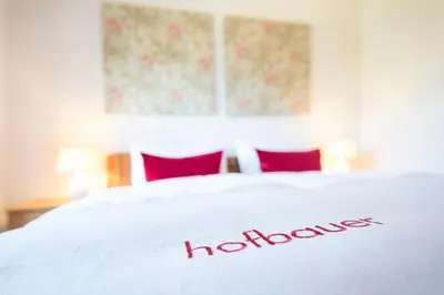 a white bed with a hollywood sign on it at Hofbauer in Brunico