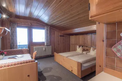 a small room with a bed and a couch at Apartments La Vara in Corvara in Badia