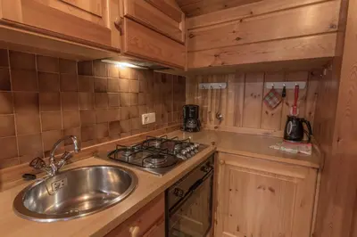 a kitchen with a sink and a stove at Apartments La Vara in Corvara in Badia