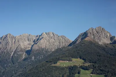 a view of a mountain with trees and mountains at Unterthurnerhof in Rifiano