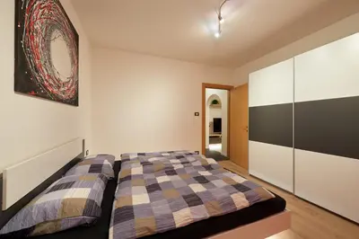 a bedroom with a bed and a painting on the wall at Villa Romana Meran in Merano