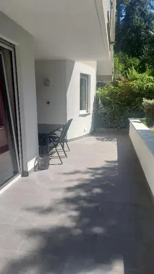 a patio with two chairs and a table in a house at Villa Romana Meran in Merano