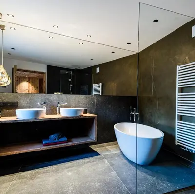 a bathroom with two sinks and a large tub at Mi Coa in Santa Cristina in Val Gardena