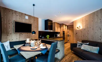a living room with a table and a couch at Mi Coa in Santa Cristina in Val Gardena