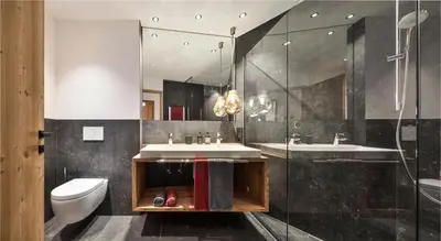 a bathroom with a sink and a toilet and a shower at Mi Coa in Santa Cristina in Val Gardena