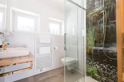 a bathroom with a shower and a toilet and a sink at Residence Bergblick in Bressanone