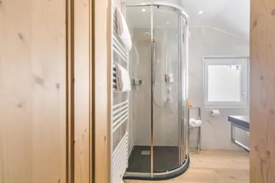 a shower with a glass door in a bathroom at Residence Bergblick in Bressanone