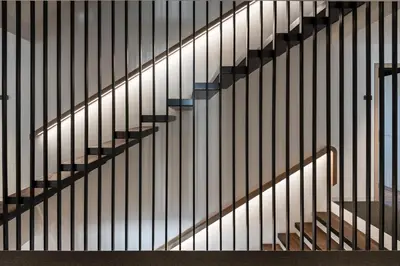 a stairway with black and white stair railing at Alpin & Stylehotel Die Sonne in Parcines