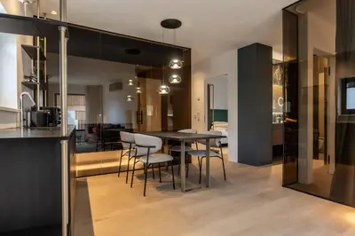 a kitchen and dining room with a table and chairs at Alpin & Stylehotel Die Sonne in Parcines