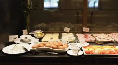 a buffet with eggs eggs and other foods on a table at Hotel Rosengarten in Nova Levante