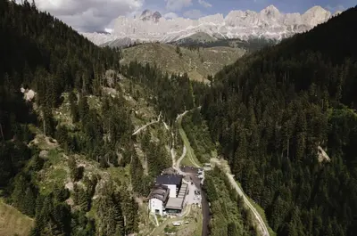 a train on the tracks in the mountains at Hotel Rosengarten in Nova Levante