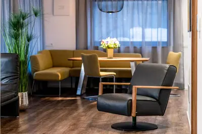 a room with a table and chairs and a table and chairs at Apartments Rumanon in Ortisei