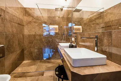a bathroom with two sinks and a mirror at Apartments Rumanon in Ortisei