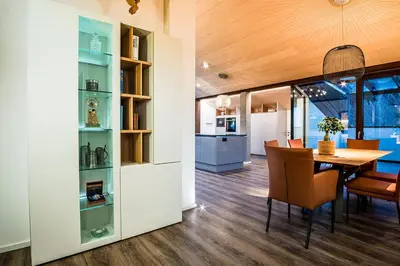 a dining room and kitchen with a table and chairs at Apartments Rumanon in Ortisei