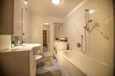 a bathroom with a sink and a tub and a toilet at Apartment Sellablick in Ortisei