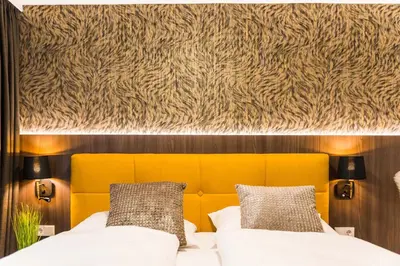 a bedroom with a bed with a yellow headboard at Gerharts Premium City Living - center of Brixen with free parking and Brixencard in Bressanone