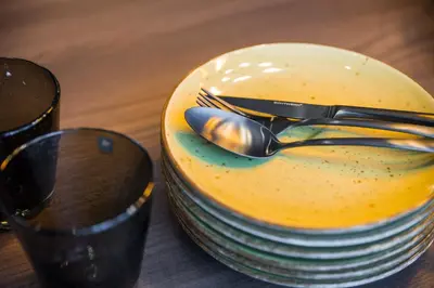 a plate with forks and spoons on a table at Gerharts Premium City Living - center of Brixen with free parking and Brixencard in Bressanone