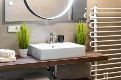 a bathroom with a white sink and a mirror at Gerharts Premium City Living - center of Brixen with free parking and Brixencard in Bressanone
