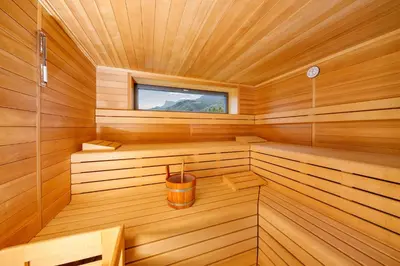 a wooden sauna with a bucket in it at Ferienhaus Törggelehof in Cermes