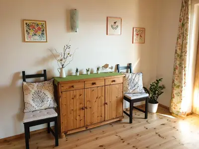 a room with two chairs and a wooden cabinet at Birbamergut in Longomoso