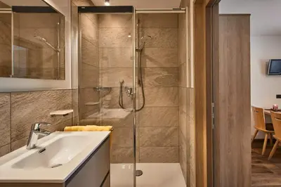 a bathroom with a shower and a sink at Saina in Colfosco