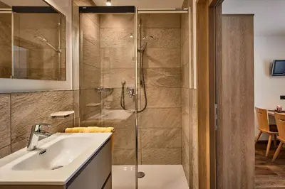 a bathroom with a shower and a sink at Saina in Colfosco