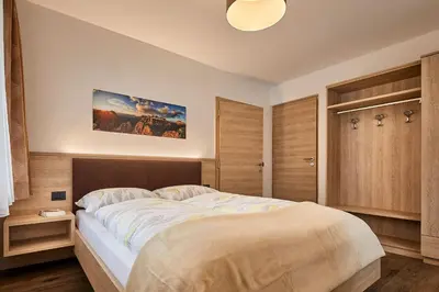 a bedroom with a large bed in a room at Saina in Colfosco