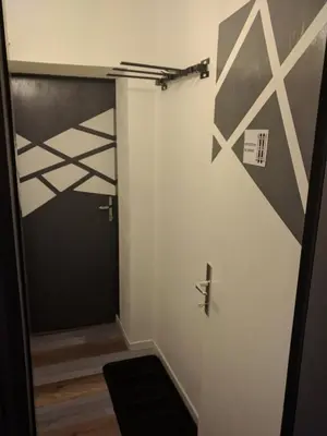 a hallway with a door with a black and white wall at Regina del Bosco della vicina Cavalese in Daiano
