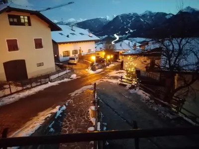 a city street with buildings and snow on the ground at Regina del Bosco della vicina Cavalese in Daiano