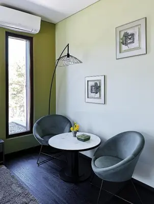 a living room with two chairs and a table at VILLA COLLINA VERDE in Bolzano